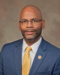 De’Keither is a figure whose life reads like a testament to service, resilience, and leadership. As a learned, Mississippi native, his roots run deep through the community’s schools, from McLeod to Timberlawn, Siwell to Forest Hill, where his early life in public education set the foundation for his formidable character.
Following high school, De’Keither sought to serve his country and joined the United States Marine Corps, a decision that would lead him on an extraordinary journey, including three years in the esteemed role of Presidential Security for Presidents Bill Clinton and George Bush. His dedication to service didn’t stop there; De’Keither then took his commitment overseas, working with the State Department in various capacities across Africa, Switzerland, and the United Kingdom.
With a relentless spirit, he re-enlisted, this time with the Army in 2005, driven by a desire to be on the ground in Iraq. There, he joined the ranks of the 82nd Airborne Division, enduring back-to-back deployments, a testament to his endurance and commitment to the cause of freedom.
De’Keither’s world experience is vast—not just geographically, but in the breadth of humanity he has encountered. He has engaged in global dialogue, trained with fellow servicemen and women, fought on battlefields, and faced life’s toughest challenges head-on.
Back home in Jackson, De’Keither transitioned his service from global to local. He served as City Councilman for Ward 4, where he advocated for the community that raised him. As the Mississippi State Representative for District 66, he continued to champion the needs and aspirations of his constituents.
Now, with his role of Public Service Commissioner for the Central Mississippi District, De’Keither aims to leverage his depth of experience in public service to ensure a brighter, more efficient future for his home state.
Family is the cornerstone of De’Keither’s life. He is a devoted son to Mr. & Mrs. Delmar Stamps of Jackson and Debra Sturgis of Crystal Springs. His greatest pride, however, is his family who inspires him every day to build a legacy of service and integrity.
This is De’Keither Stamps: a man shaped by service, tested by conflict, and driven by a profound love for his family and community. Join him in his journey as he seeks to bring his lifetime of service to the people of Mississippi through the office of Public Service Commissioner. De’Keither is a figure whose life reads like a testament to service, resilience, and leadership. As a learned, Mississippi native, his roots run deep through the community’s schools, from McLeod to Timberlawn, Siwell to Forest Hill, where his early life in public education set the foundation for his formidable character.
Following high school, De’Keither sought to serve his country and joined the United States Marine Corps, a decision that would lead him on an extraordinary journey, including three years in the esteemed role of Presidential Security for Presidents Bill Clinton and George Bush. His dedication to service didn’t stop there; De’Keither then took his commitment overseas, working with the State Department in various capacities across Africa, Switzerland, and the United Kingdom.
With a relentless spirit, he re-enlisted, this time with the Army in 2005, driven by a desire to be on the ground in Iraq. There, he joined the ranks of the 82nd Airborne Division, enduring back-to-back deployments, a testament to his endurance and commitment to the cause of freedom.
De’Keither’s world experience is vast—not just geographically, but in the breadth of humanity he has encountered. He has engaged in global dialogue, trained with fellow servicemen and women, fought on battlefields, and faced life’s toughest challenges head-on.
Back home in Jackson, De’Keither transitioned his service from global to local. He served as City Councilman for Ward 4, where he advocated for the community that raised him. As the Mississippi State Representative for District 66, he continued to champion the needs and aspirations of his constituents.
Now, with his role of Public Service Commissioner for the Central Mississippi District, De’Keither aims to leverage his depth of experience in public service to ensure a brighter, more efficient future for his home state.
Family is the cornerstone of De’Keither’s life. He is a devoted son to Mr. & Mrs. Delmar Stamps of Jackson and Debra Sturgis of Crystal Springs. His greatest pride, however, is his family who inspires him every day to build a legacy of service and integrity.
This is De’Keither Stamps: a man shaped by service, tested by conflict, and driven by a profound love for his family and community. Join him in his journey as he seeks to bring his lifetime of service to the people of Mississippi through the office of Public Service Commissioner.
